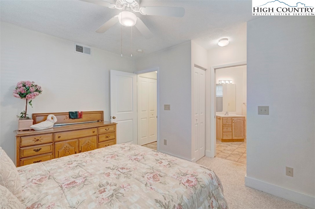 190 Still Lake Drive, Unit 321 Boone, NC 28607 - Photo 18 of 30 a bedroom with a bed and a dresser