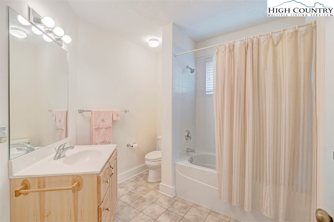 190 Still Lake Drive, Unit 321 Boone, NC 28607 - Photo 20 of 30 a bathroom with a sink a toilet and shower