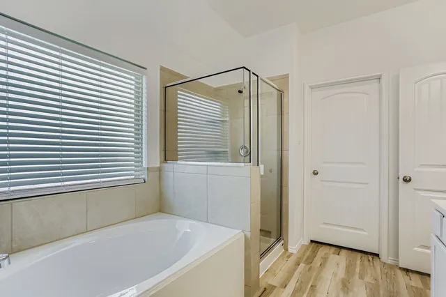 a bathroom with a bathtub and a shower