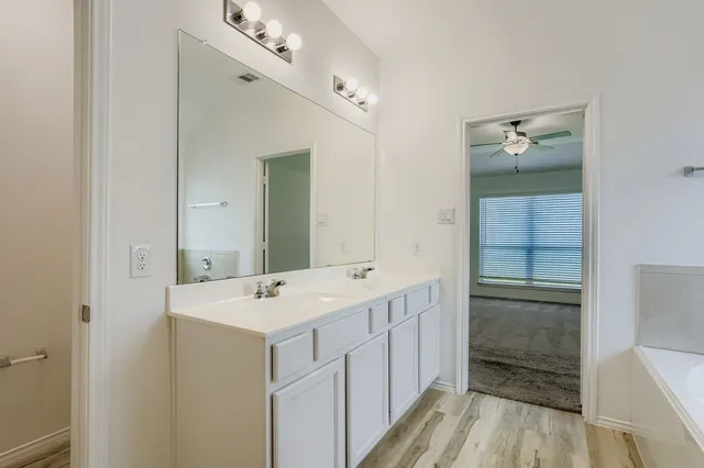 a bathroom with a sink a mirror and a shower