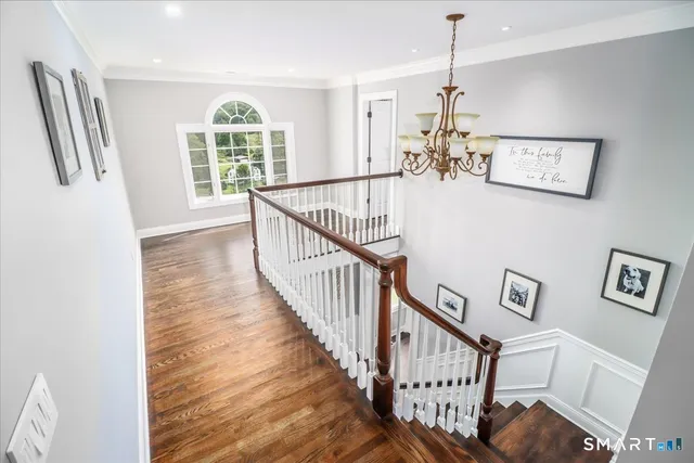 a view of entryway and hall with wooden floor