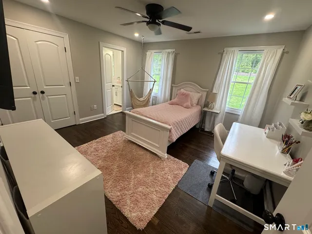 a bedroom with a bed and a table in it