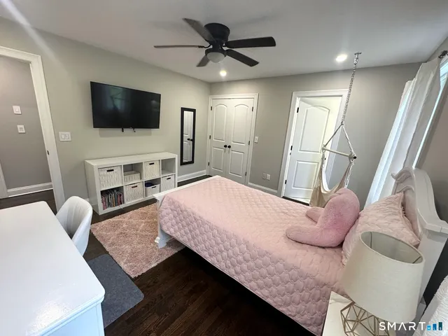 a bedroom with a bed and a flat screen tv