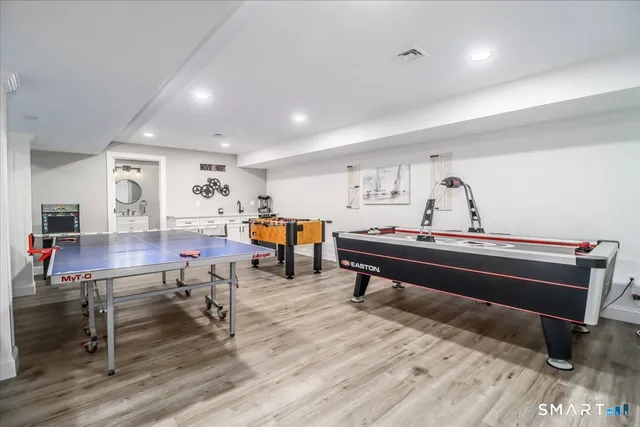 a reading room with furniture and wooden floor