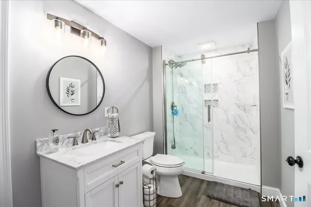 a bathroom with a toilet sink and a mirror