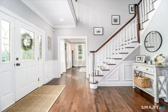 a view of an entryway with wooden floor and door
