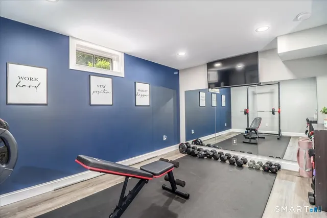 a room with gym equipment and a flat screen tv