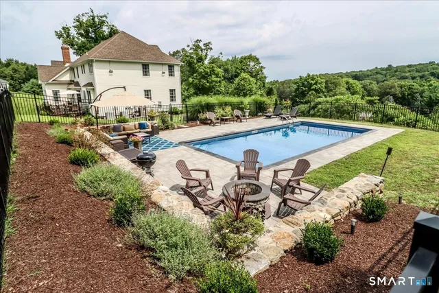 a view of swimming pool with chairs