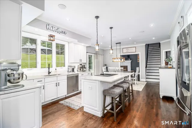 a kitchen with counter top space a sink appliances and cabinets