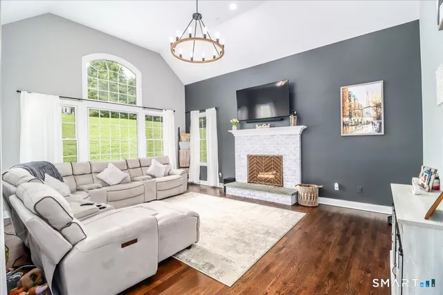 a living room with furniture fireplace and a flat screen tv