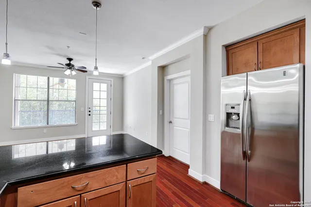 a kitchen with stainless steel appliances granite countertop a refrigerator a sink and a granite counter tops