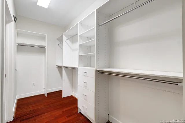 a view of walk in closet with empty racks