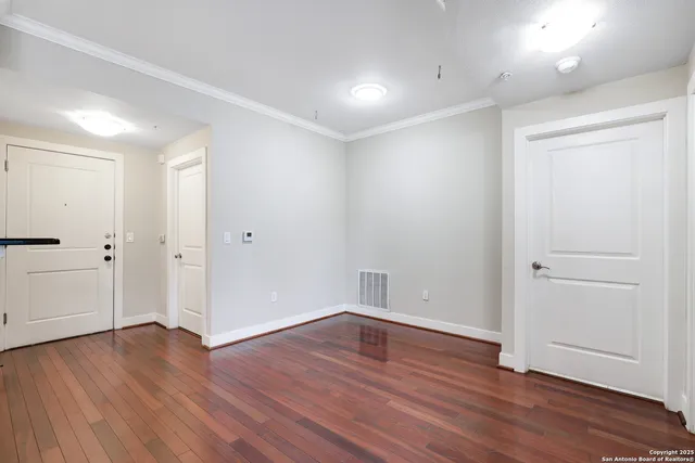 an empty room with wooden floor