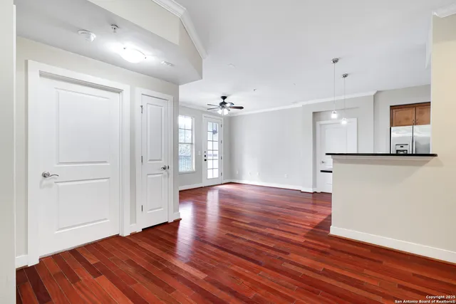 a view of a room with wooden floor and a window