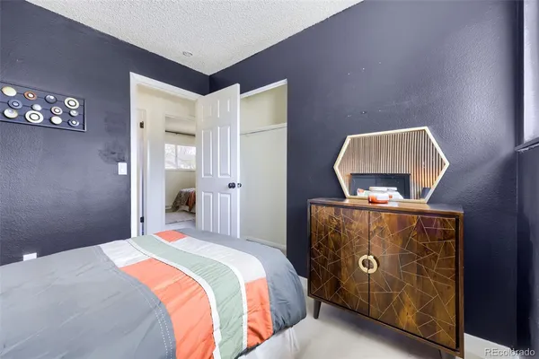 a bedroom with a bed and a dresser