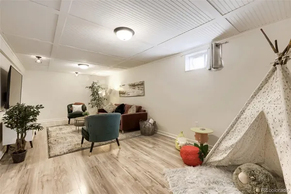 a living room with furniture and a potted plant
