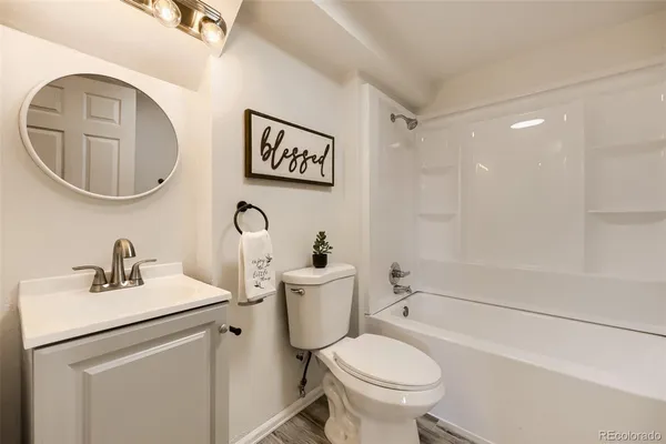a bathroom with a toilet a sink and a mirror