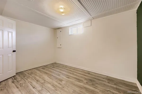 a view of a room with wooden floor