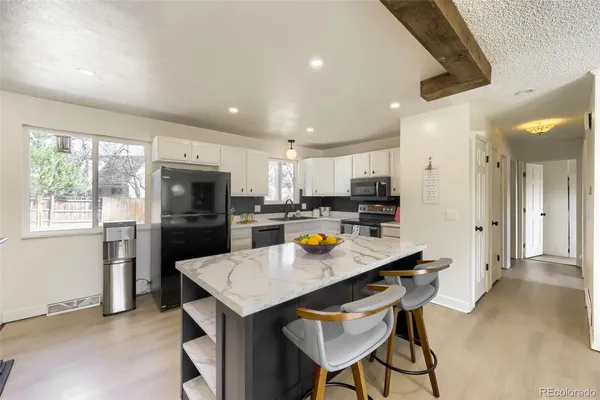 a kitchen with refrigerator and cabinets