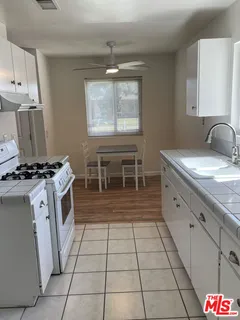 a kitchen with a sink and a stove top oven