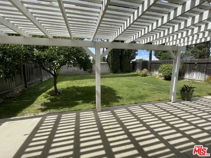 a view of a patio with a yard