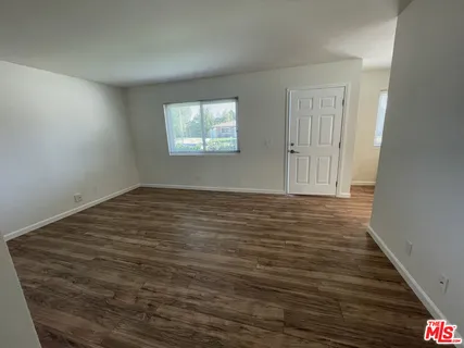 a view of a room with wooden floor
