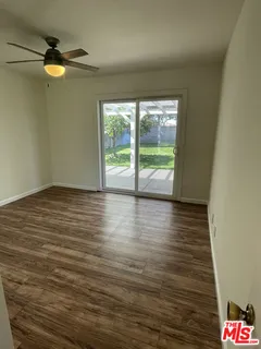 a view of an empty room and wooden floor