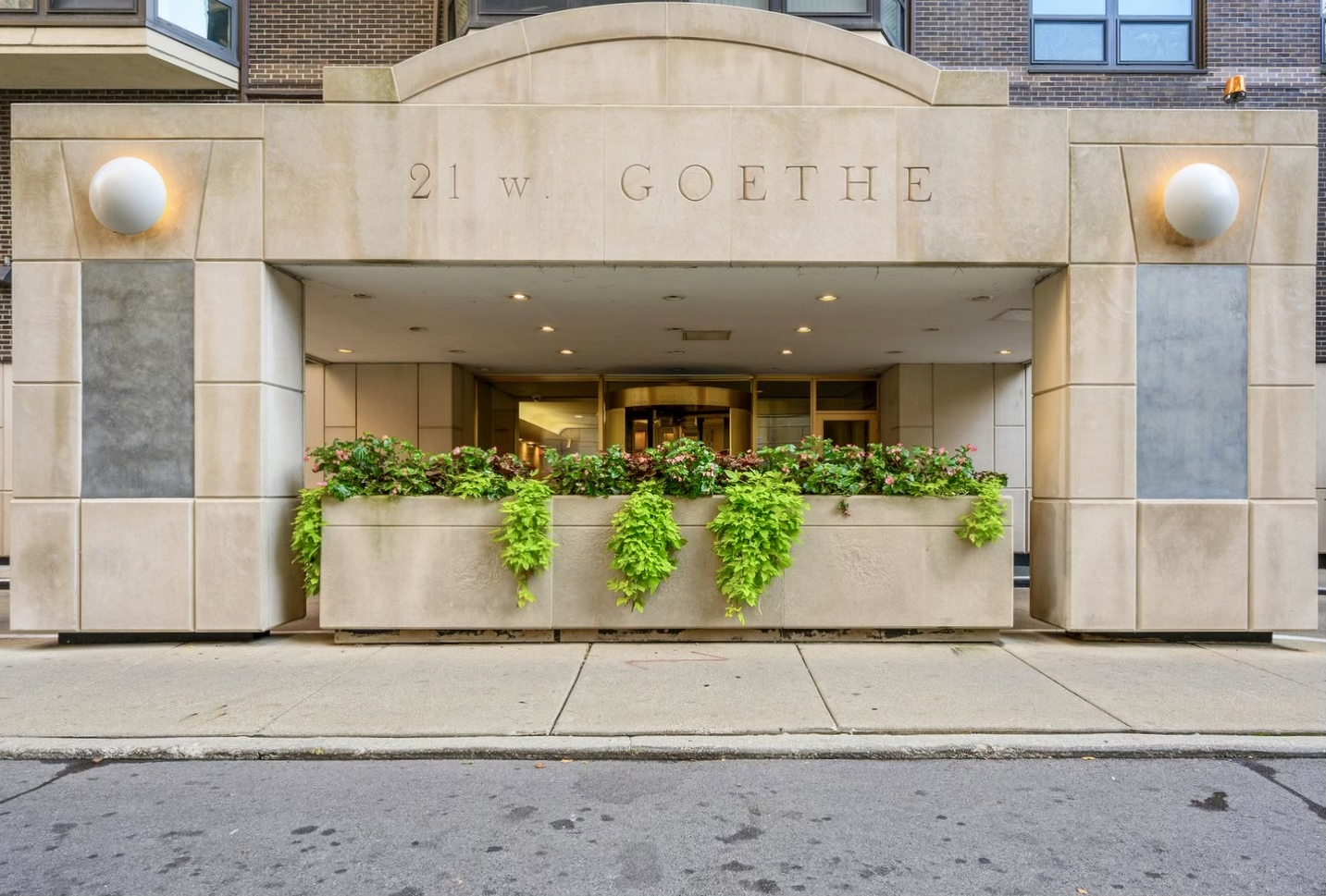 a front view of a building with potted plants