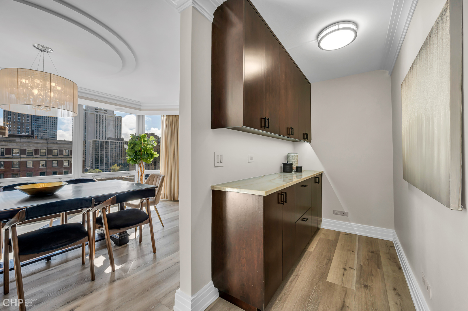 21 West Goethe Street, Unit 10G Chicago, IL 60610 - Photo 12 of 39 a kitchen with stainless steel appliances granite countertop a table chairs and a refrigerator