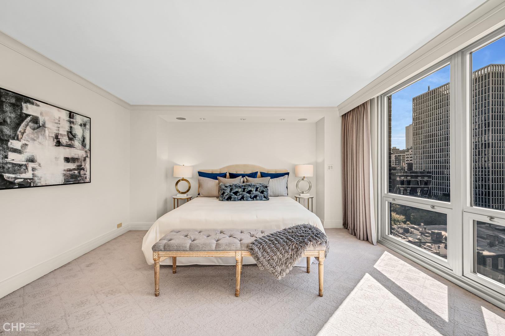 21 West Goethe Street, Unit 10G Chicago, IL 60610 - Photo 18 of 39 a bedroom with a bed lamp and a large window