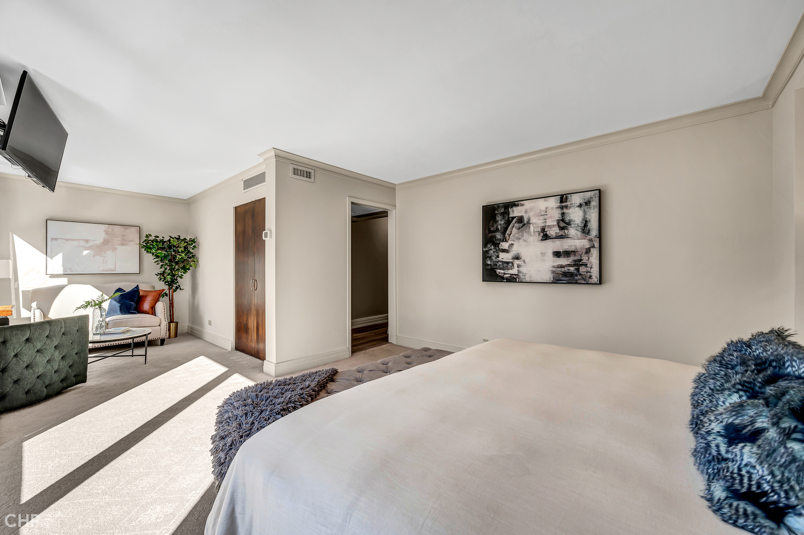 21 West Goethe Street, Unit 10G Chicago, IL 60610 - Photo 20 of 39 a bedroom with a large bed and a flat screen tv