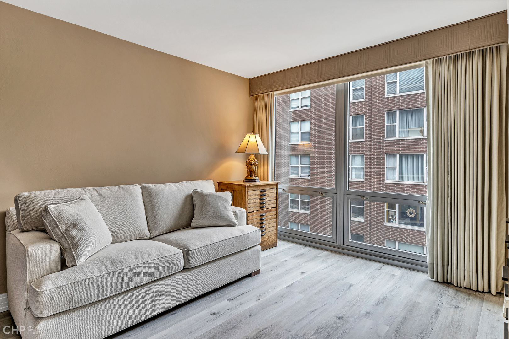 21 West Goethe Street, Unit 10G Chicago, IL 60610 - Photo 27 of 39 a living room with furniture and wooden floor