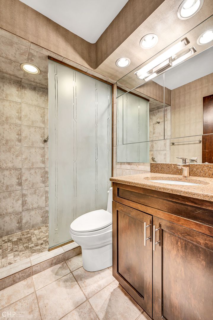 21 West Goethe Street, Unit 10G Chicago, IL 60610 - Photo 29 of 39 a bathroom with a sink a toilet and shower