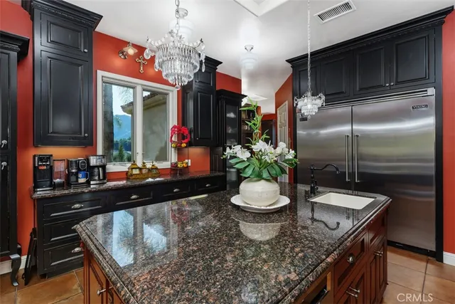 a bedroom with a large bed and a fireplace