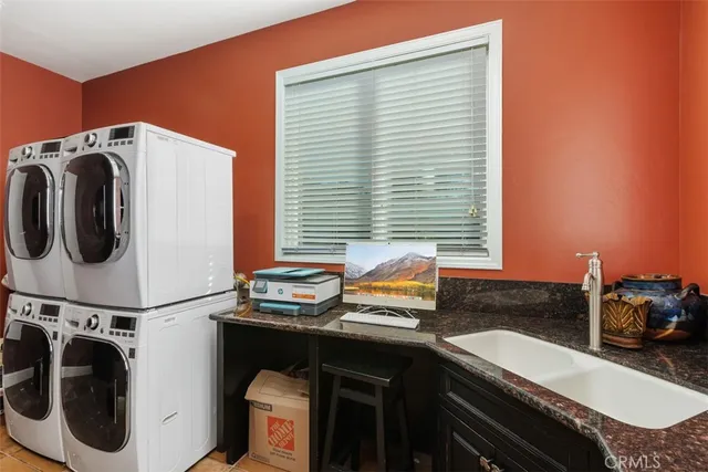 a bedroom with a bed and a chandelier fan