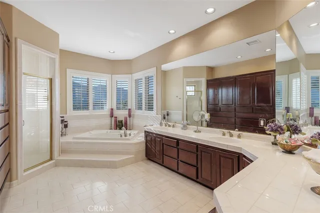 a bathroom with a tub a sink and glass door