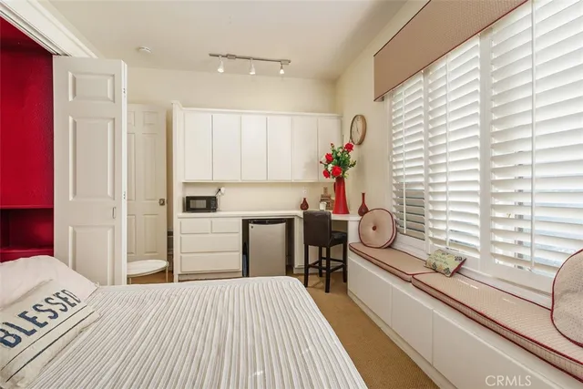 a front view of a house with a garden and yard