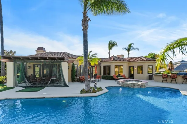 outdoor view of a house with swimming pool and a yard