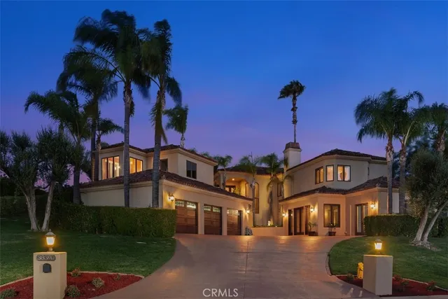 an aerial view of a house with a garden and trees