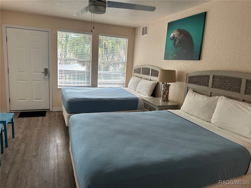 5291 South Cherokee Way Homosassa, FL 34448 - Photo 12 of 27 a large bed sitting in a bedroom next to a window