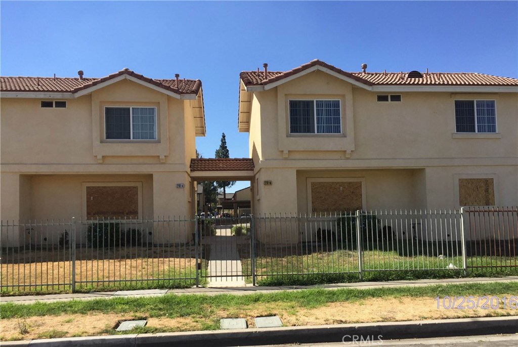 218 North Spruce Avenue Rialto, CA 92376 - Photo 1 of 1 a front view of a house with a yard
