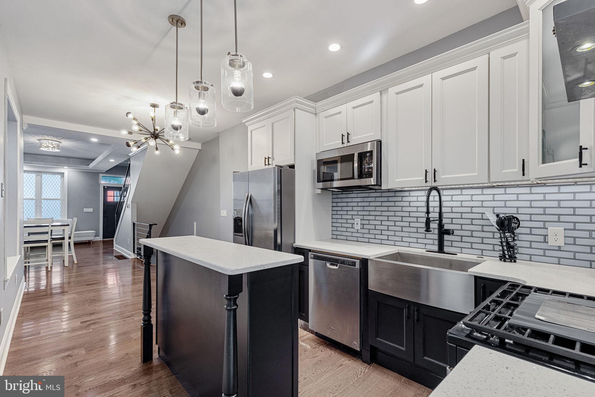 a kitchen with a sink appliances and cabinets