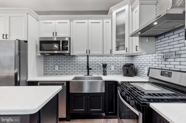 a kitchen with a table chairs and wooden floor