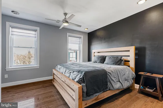 a bedroom with a large bed and a window