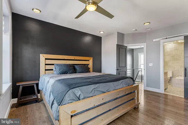 a bedroom with a bed and a ceiling fan