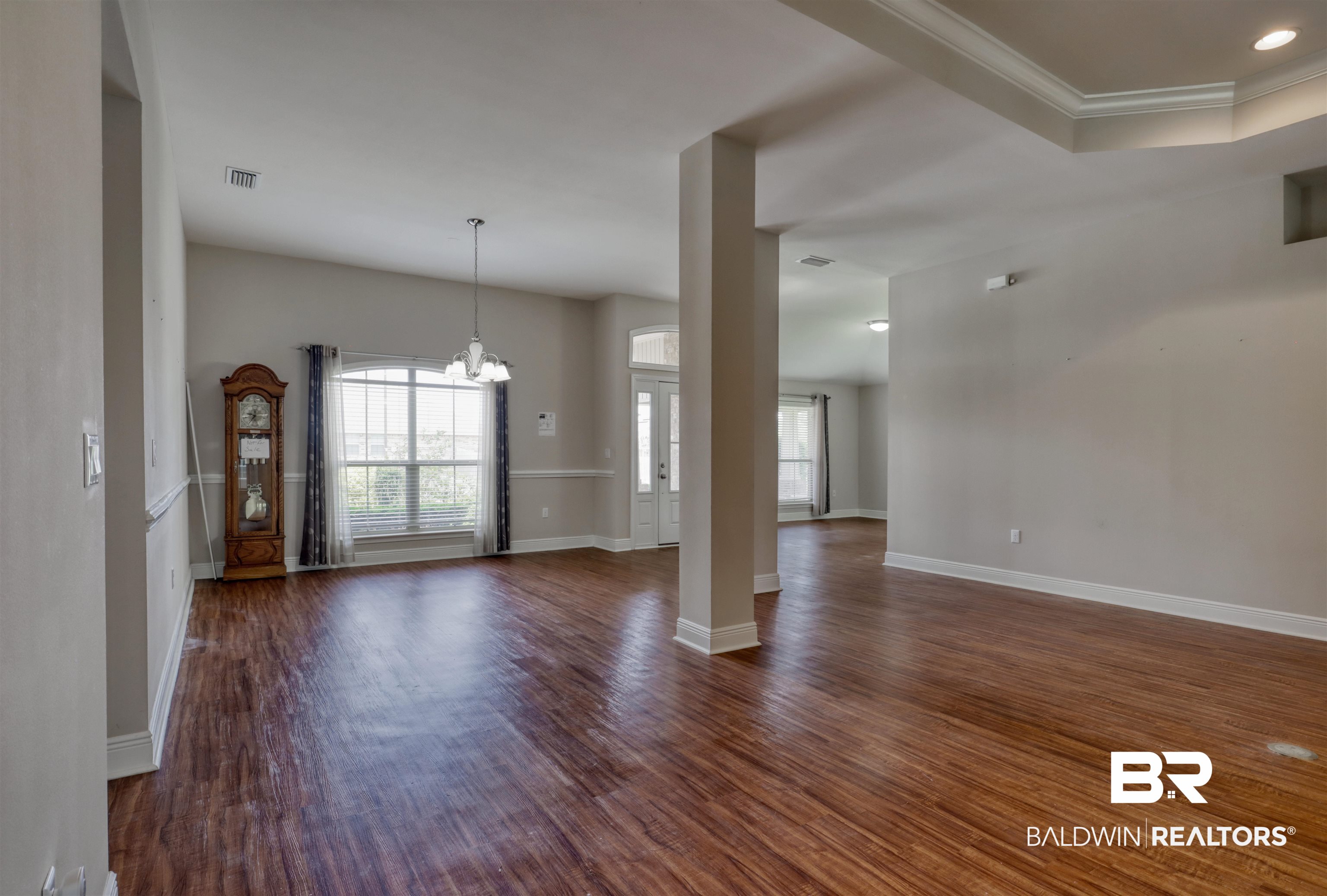14794 Troon Drive Foley, AL 36535 - Photo 5 of 33 Unfurnished living room featuring an inviting chandelier, baseboards, and a wealth of natural light