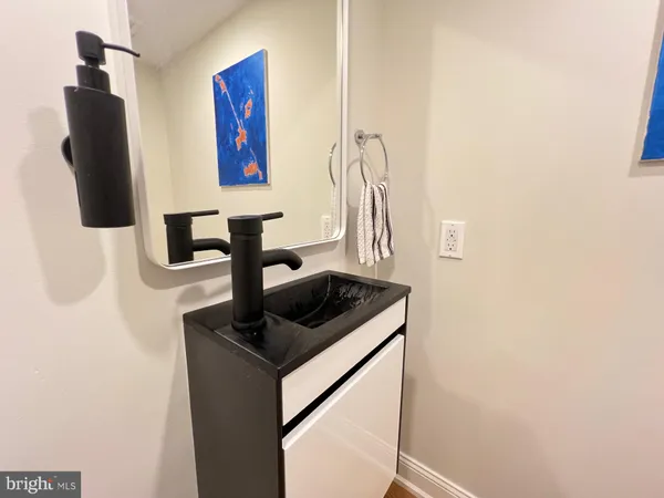 a kitchen with a sink and a mirror