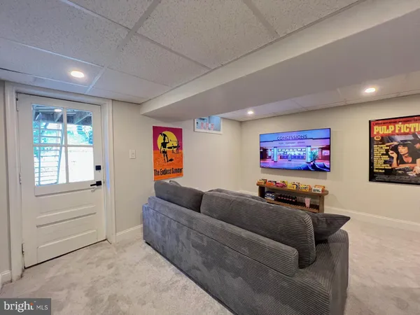 a projector room with furniture and a flat screen tv
