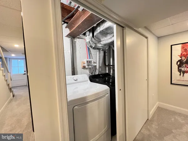 a view of storage and utility room with washer and dryer