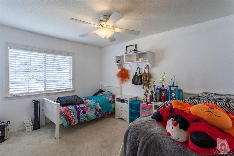 4724 Barnard Street Simi Valley, CA 93063 - Photo 15 of 30 a bedroom with bed and a chandelier